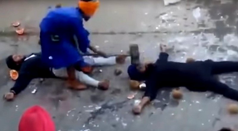 Blindfolded man slams down a sledgehammer inches from trusting