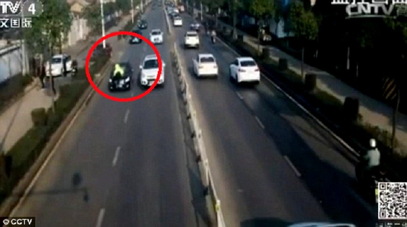 Badass Chinese Policeman Jumps on Car As It Speeds Away
