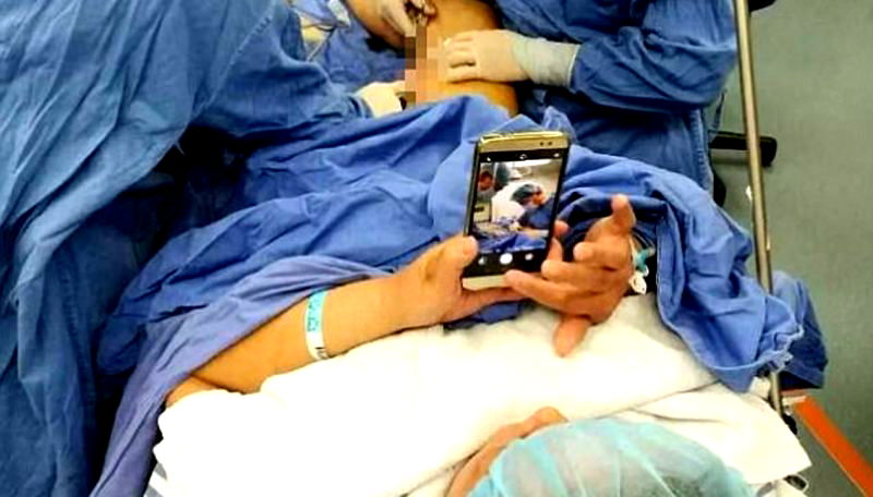 Chinese Patient Plays With Her Phone During Operation to Help With Anxiety