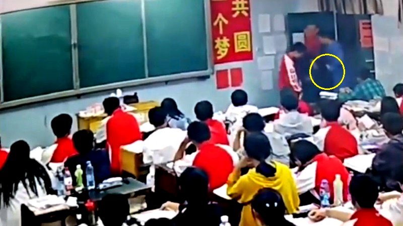 A middle school teacher in southern China has been suspended after assaulting two male students in front of the class.