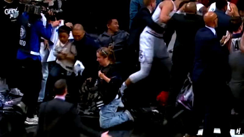 An Asian man who swiftly took his son away from a courtside ruckus is being hailed as “Dad of the Year” on social media.