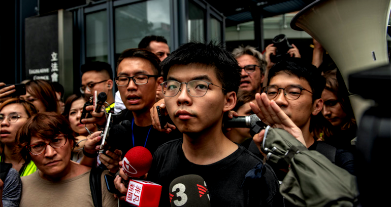 Hong Kong Activist Bundled and Shoved Into a Van by Police Right Before Protests