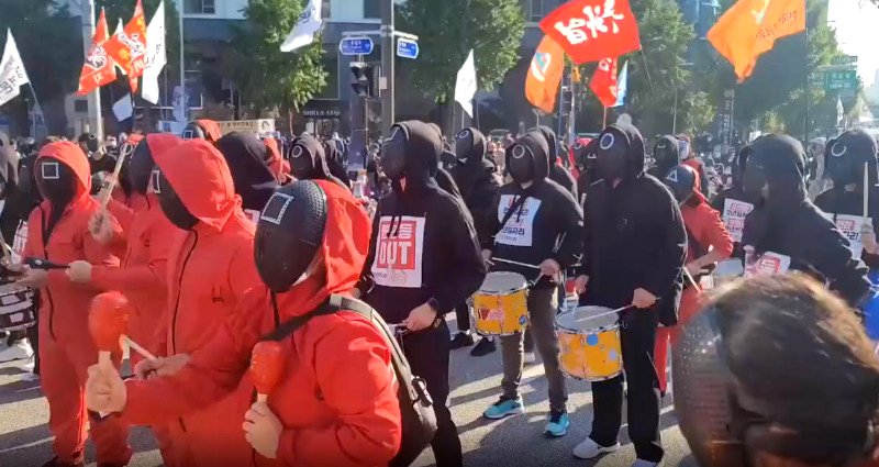 Workers flood the streets of Seoul wearing ‘Squid Game’ attire to protest for better working conditions
