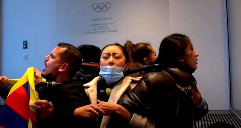 Tibetan students chain themselves to Olympics logo in front of IOC to protest Beijing 2022