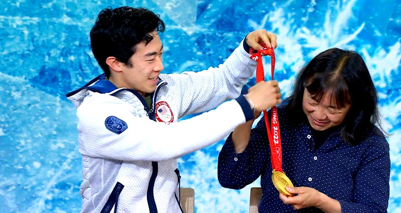 Nathan Chen places his gold medal around his mother’s neck in their first reunion since the Olympics