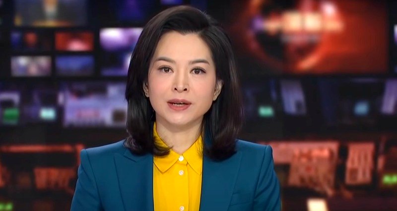 Chinese news anchor wears Ukrainian flag colors while reporting NATO is responsible for Russian invasion