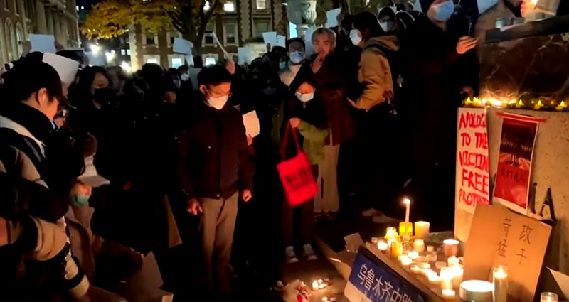 Hundreds across US hold up blank sheets of paper while protesting in solidarity with Chinese citizens