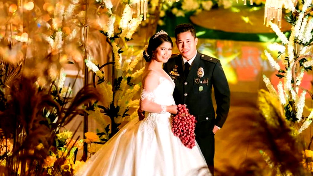 Filipino bride walks down the aisle with onion bouquet