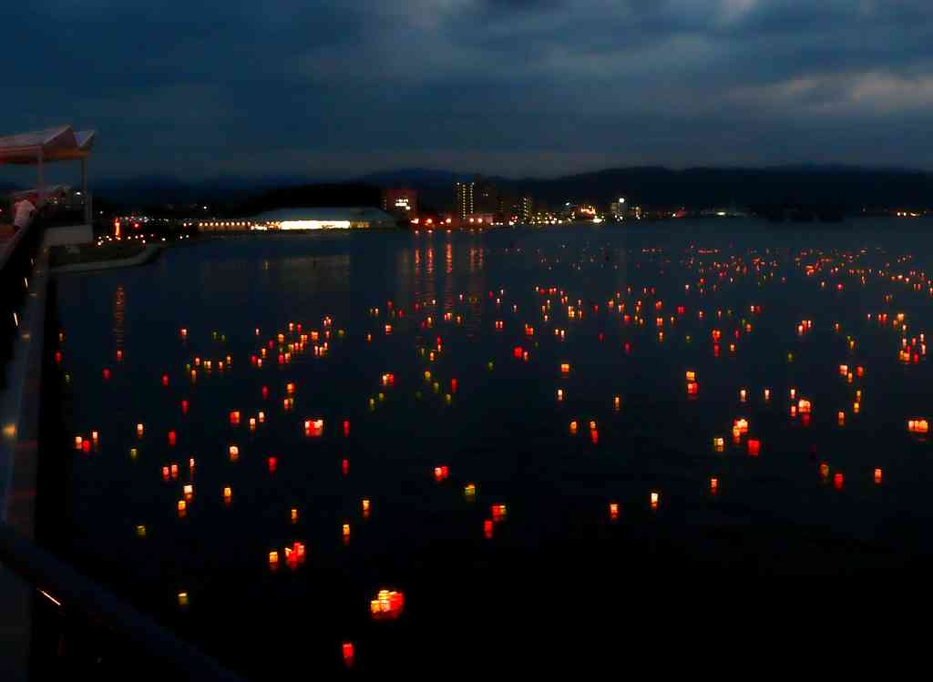 Colorful paper lanterns are placed on a lake at the end of Obon festival in Matsue, Japan.